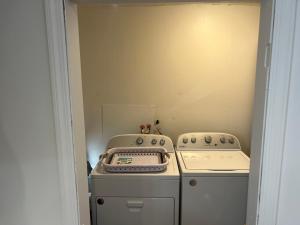 a kitchen with a stove and a washer and dryer at Renovated 3 BR Ewing Home -Quiet in Trenton