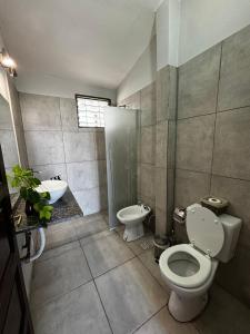 a bathroom with a toilet and a sink at Casa 'Los Colibries' in Salta