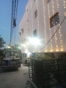 um autocarro estacionado em frente a um edifício com luzes em Hotel Fortune Residency em Nova Deli