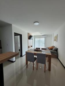 a kitchen and dining room with a table and chairs at Veneto Village Resort & Spa in Villa Carlos Paz