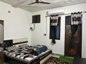 a room with a bed with pillows on it at Entire family vacation home in Vrindāvan
