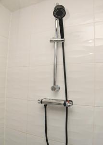 a shower head holder in a bathroom at AmazenHome - Stylish 3 bed - House of Ebony in Leigh