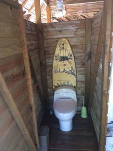 a bathroom with a toilet in a wooden structure at El Toucan Loco floating lodge in Tierra Oscura