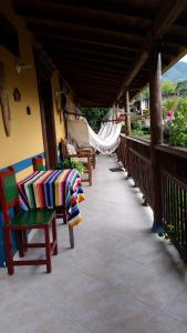 a porch with chairs and hammocks on a house at Chalet De Chalo in Jardin