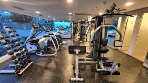 a gym with several treadmills and cardio machines at Quiet Low Level Lake View 3BRs Lippo Cikarang EJIP -Min Stay 3 Nights- in Bekasi
