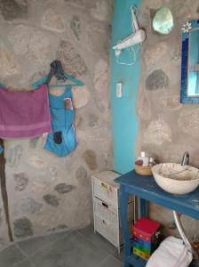 a bathroom with a sink and a stone wall at CasaIsolina in San Javier