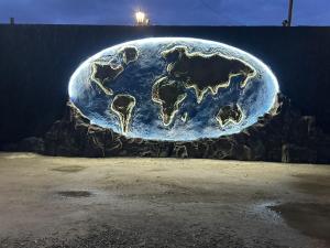 a painting of the earth on a rock at Friend's House rooms near Airport in Yerevan