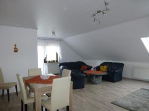 a living room with a couch and a table at Ferienwohnung Irmgard und Ferienwohnung Gerlinde in Waldbrunn