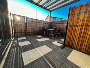 a patio with a table and chairs on a balcony at Zoela in Izola