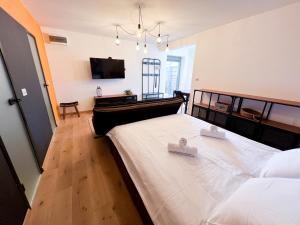 a bedroom with a large bed with two white towels at Zoela in Izola