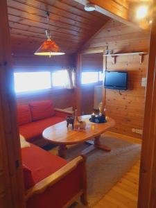 a living room with a couch and a table at Kvamskogen & Hardanger Holliday homes in Norheimsund