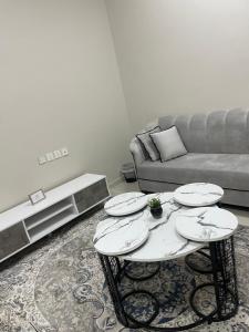 همس المدينة شقة مفروشة في آبار علي: غرفة معيشة مع طاولة وأريكة