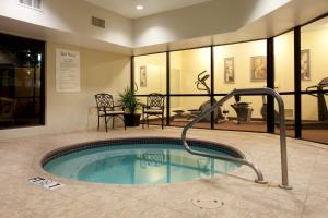 a swimming pool with a hot tub in a building at Holiday Inn Express & Suites Sulphur - Lake Charles, an IHG Hotel in Sulphur
