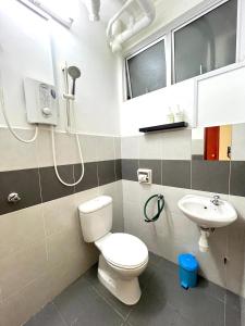 a bathroom with a toilet and a sink at Seaview Holiday Apartment 3 - WiFi & Netflix in Kuala Terengganu