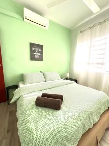a bedroom with a large bed with a brown pillow on it at Seaview Holiday Apartment 3 - WiFi & Netflix in Kuala Terengganu