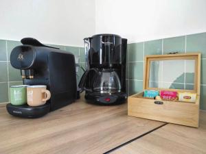 a coffee maker sitting on a counter next to a mirror at Gîte in Etretat near Cliffs & Beach in Bordeaux-Saint-Clair