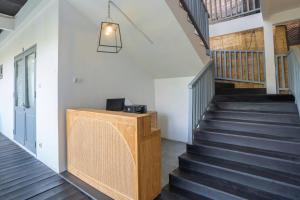 a staircase in a house with black stairs at The Peacock Inn in Ubud