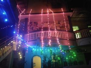 a building with christmas lights on it at night at Advait Holiday Home in Nagaon