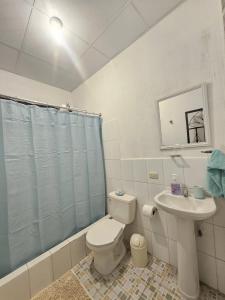 a bathroom with a toilet and a sink at Blue Moon Hostel in Antigua Guatemala