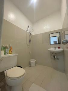 a bathroom with a toilet and a sink at The Premier Suite in Pusok