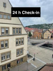 a picture of a building with the words h check in at TRUST Hotel & Apartment in Stuttgart
