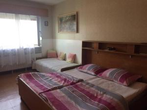 a bedroom with two beds and a window at Apartments with parking space Crikvenica - 20720 in Crikvenica
