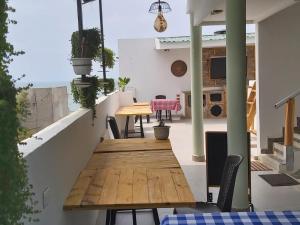 an outdoor patio with a wooden table and chairs at Dreimar Hotel Boutique in Cartagena de Indias