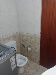 a bathroom with a toilet and a toilet paper dispenser at La Soñada in Tandil