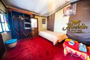 a room with a bed in a tent at Aladdin Desert Camp in El Gouera