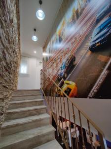 a staircase with a painting of cars on the wall at Casona Torrent in Torrent