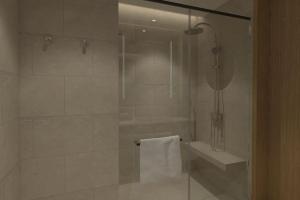 a bathroom with a shower with a toilet and a sink at Courtyard by Marriott Kuala Lumpur South in Kuala Lumpur