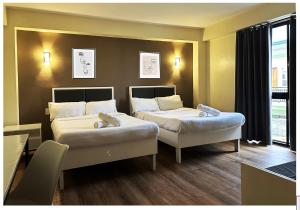 Voodi või voodid majutusasutuse D'ELEMENTS HOTEL AND DORMITORY toas