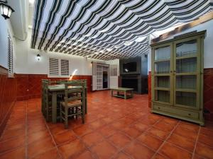 a room with a table and a bench and a ceiling at Casona Torrent in Torrent