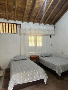 Postel nebo postele na pokoji v ubytování Majestic Coffee Hotel and Restaurant Tierradentro