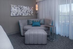a room with a couch and a chair and a table at Courtyard by Marriott Lynchburg in Lynchburg