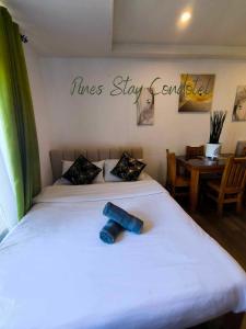 een kamer met twee bedden en een bord met regels, blijf centraal bij Megatower 4 6F 24 Pines Stay Condotel Near SM & Burnham in Baguio