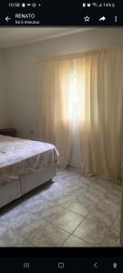 um quarto com uma cama e uma janela com cortinas em Chacara Condomínio Monte Verde Itu em Itu