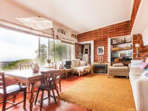 a living room with a wooden table and a brick wall at The Shelter in Malveira da Serra