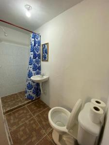 a bathroom with a toilet and a sink at Bedrooms where Charlie in El Paredón Buena Vista +20 photos