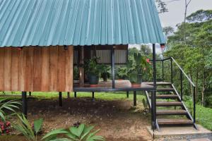 a house with a staircase and a blue roof at Quinta Túru in Colonia +16 photos