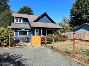 a house with a wooden gate and a fence at Delightful family-friendly home in the heart of WA in Olympia