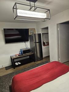 a bedroom with a large bed and a refrigerator at Mountain View Hope Motel in Hope