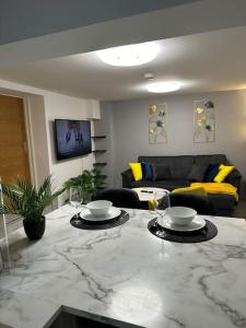 a living room with a table with two wine glasses at Stylish entire 2bed apartment in London