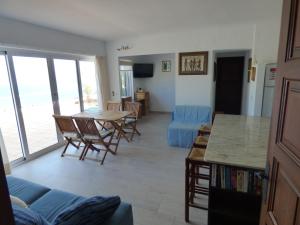 a living room with a table and a blue couch at "La Terrasse de la mer 8" -Climatisation-Wifi-BBQ -Piscine-Parking in Begur