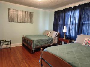 a bedroom with two twin beds and a window at Welcome To Downtown Pickens close to Clemson and Lake Keowee in Pickens