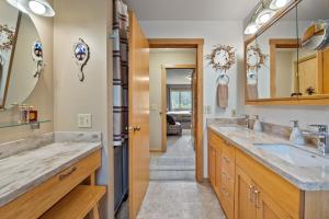 a bathroom with two sinks and a large mirror at Bear Lake Lodgings B&B in Seward