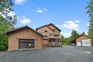 a house with two garage buildings and a driveway at Bear Lake Lodgings B&B in Seward
