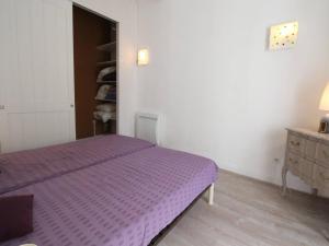 a bedroom with a purple bed and a dresser at Appartement Bagnères-de-Luchon, 2 pièces, 4 personnes - FR-1-313-230 in Luchon