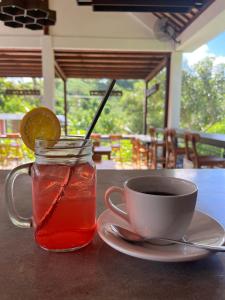 a cup of tea and a cup of coffee on a table at The Local Are Guling in Kuta Lombok