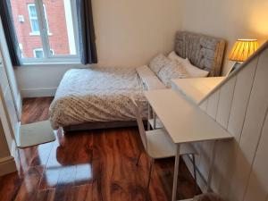 a small room with a bed and a desk at Scotland Street, Newton Heath in Manchester +36 photos